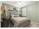 Bedroom showcasing a ceiling fan, window with green walls and decor at 5220 Sunshine Dr, Wildwood, FL 34785
