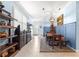 Dining and Entry showcasing wooden table, decorative shelving, wainscoting and natural light enhancing the space at 5220 Sunshine Dr, Wildwood, FL 34785