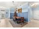 Dining room showcasing a wood table set on a patterned rug, complemented by wainscoting and elegant light fixture at 5220 Sunshine Dr, Wildwood, FL 34785