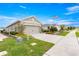 Attractive single Gathering home with a two car garage, an American flag, and nice landscaping at 5220 Sunshine Dr, Wildwood, FL 34785