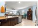 Kitchen featuring granite countertops, stainless steel appliances, and seamless transition into a comfortable living space at 5220 Sunshine Dr, Wildwood, FL 34785