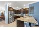 A kitchen featuring granite countertops, stainless steel appliances, and a stylish backsplash design at 5220 Sunshine Dr, Wildwood, FL 34785