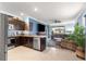 Contemporary kitchen with granite countertops, stainless steel appliances, and open access to the living area at 5220 Sunshine Dr, Wildwood, FL 34785