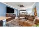 Cozy living room with plush furniture, a large TV, and a view of the outdoor patio at 5220 Sunshine Dr, Wildwood, FL 34785