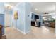 Open-concept living area with tiled floors, stainless steel appliances, and a seamless transition to the cozy living room at 5220 Sunshine Dr, Wildwood, FL 34785