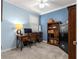 Office space features a wooden desk, bookshelf, and comfortable chair at 5220 Sunshine Dr, Wildwood, FL 34785