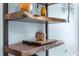 Rustic shelves with decorative objects against a blue wall provide a unique design at 5220 Sunshine Dr, Wildwood, FL 34785