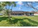 A lush green lawn leads to the screened pool, perfect for outdoor enjoyment at 5350 Sw 82Nd St, Ocala, FL 34476