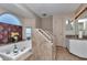 Bathroom featuring a large soaking tub, tile surround, and a separate vanity area at 5350 Sw 82Nd St, Ocala, FL 34476