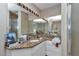 Bathroom featuring granite countertops, white cabinets, and a mirror at 5350 Sw 82Nd St, Ocala, FL 34476