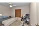 Neutral bedroom with ceiling fan, window with wood blinds, and basic furniture arrangement at 5350 Sw 82Nd St, Ocala, FL 34476