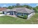 Aerial view of light blue one-story home, with a well-manicured green lawn and mature landscaping at 5350 Sw 82Nd St, Ocala, FL 34476