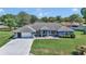 Aerial view of light blue one-story home, with a manicured green lawn and a two car garage at 5350 Sw 82Nd St, Ocala, FL 34476