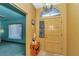 Inviting foyer features decorative front door, tile floor, and charming accent table at 5350 Sw 82Nd St, Ocala, FL 34476