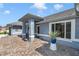 Covered front porch with stone walkway and seating area and light blue siding at 5350 Sw 82Nd St, Ocala, FL 34476