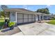 Two-car garage of a single-story home with a concrete driveway and a gray door at 5350 Sw 82Nd St, Ocala, FL 34476