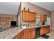 Kitchen featuring solid surface countertops, light brown cabinets, tile flooring, and stainless steel appliances at 5350 Sw 82Nd St, Ocala, FL 34476
