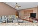 Cozy living room featuring hardwood floors, plaid sofas, and a ceiling fan at 5350 Sw 82Nd St, Ocala, FL 34476