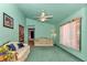 Cozy living room features bright green walls, fan and plush furniture at 5350 Sw 82Nd St, Ocala, FL 34476