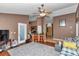 Living room offering hardwood floors, ceiling fan, and access to the kitchen and front door at 5350 Sw 82Nd St, Ocala, FL 34476