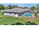 A screened-in pool area is surrounded by well-maintained grass at 5350 Sw 82Nd St, Ocala, FL 34476