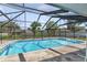 Refreshing screened-in pool featuring clear blue water, ladder, steps, and views of neighboring houses at 5350 Sw 82Nd St, Ocala, FL 34476