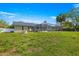 Expansive backyard featuring a screen-enclosed pool, patio furniture, fire pit, and lush greenery at 5580 Se 21St Ln, Ocala, FL 34480