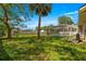 Spacious backyard featuring a screened-in pool area, mature trees, and a well-maintained lawn at 5580 Se 21St Ln, Ocala, FL 34480
