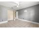 Small bedroom featuring tile floor, a ceiling fan, and closet space for a functional and comfortable living area at 5580 Se 21St Ln, Ocala, FL 34480