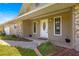 Inviting front entrance with a decorative white door, stone accents, and manicured landscaping at 5580 Se 21St Ln, Ocala, FL 34480