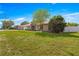 Charming single-story home boasts a well-maintained lawn, complemented by mature trees and stone accents at 5580 Se 21St Ln, Ocala, FL 34480
