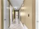 A well-lit hallway with a patterned tile floor provides access to various rooms, including a bathroom, in the home at 5580 Se 21St Ln, Ocala, FL 34480