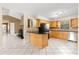 Open-concept kitchen featuring a breakfast bar and stainless steel appliances at 5580 Se 21St Ln, Ocala, FL 34480