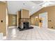 Open-concept living room featuring a stone fireplace and white tile flooring at 5580 Se 21St Ln, Ocala, FL 34480