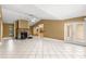 Large living room featuring tiled floors, a stone fireplace, and ample space for furniture at 5580 Se 21St Ln, Ocala, FL 34480