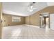 Open living room featuring tiled floors, neutral wall color, and a ceiling fan, perfect for entertaining guests at 5580 Se 21St Ln, Ocala, FL 34480