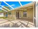Covered patio with travertine flooring, ceiling fan, outdoor lighting, and access to the backyard and pool area at 5580 Se 21St Ln, Ocala, FL 34480
