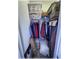 Organized walk-in closet with clothes, storage bins, and shelves for ample storage space at 6365 Se 12Th Ln, Ocala, FL 34472