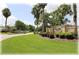 Entrance to Deer Path Estates with lush landscaping and established palm trees at 6365 Se 12Th Ln, Ocala, FL 34472
