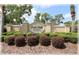 The Deer Path Estates community sign, surrounded by lush greenery and manicured bushes at 6365 Se 12Th Ln, Ocala, FL 34472