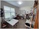 Well-lit craft room with sewing machines, work tables, and a view of the outdoors at 6365 Se 12Th Ln, Ocala, FL 34472