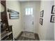 Clean and modern entryway with a white door, decor, and wood-look flooring at 6365 Se 12Th Ln, Ocala, FL 34472
