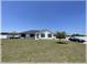 Charming, single story home with well manicured front lawn and blue convertible in the driveway at 6365 Se 12Th Ln, Ocala, FL 34472