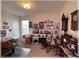 Spacious hobby room with a collection of clocks, display shelves, and a rocking chair at 6365 Se 12Th Ln, Ocala, FL 34472