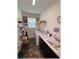 Laundry room featuring a washer and dryer with dark cabinetry and a utility sink at 6365 Se 12Th Ln, Ocala, FL 34472