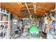 Inside of outbuilding showing lawn mower, tools, ladders, and an overhead fan at 6365 Se 12Th Ln, Ocala, FL 34472