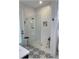 Contemporary shower featuring white subway tiles, glass enclosure, mosaic floors, and a built-in niche at 6365 Se 12Th Ln, Ocala, FL 34472