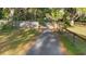 Long driveway leading to the property with mature trees and natural landscaping at 6700 Nw 57Th Ave, Ocala, FL 34482