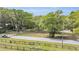 Street view of the property showcasing surrounding green space and landscaping at 6700 Nw 57Th Ave, Ocala, FL 34482