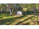 Metal storage shed in backyard and tall trees at 6700 Nw 57Th Ave, Ocala, FL 34482